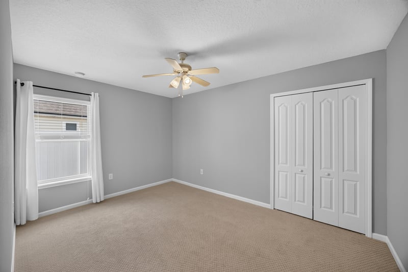 Empty room with closet doors and window unit at 85 Amia Dr, St. Augustine, FL 32086