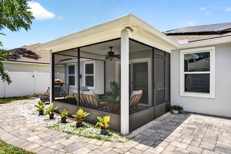 Screened porch exterior with paver patio at 10066 Andean Fox Dr, Jacksonville, FL 32222