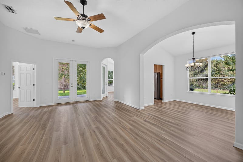 Living area with wood-look floor and French doors at 3101 E Banister Rd, St. Augustine, FL 32092