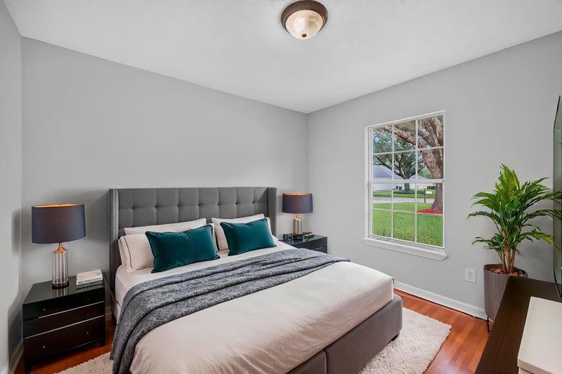 Bedroom with staged bed and ceiling fan at 456 Bay Point Way N, Jacksonville, FL 32259