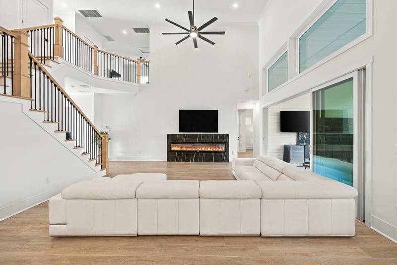 Staircase with black railing overlooking the great room at 907 Seagrove Dr, Ponte Vedra Beach, FL 32081