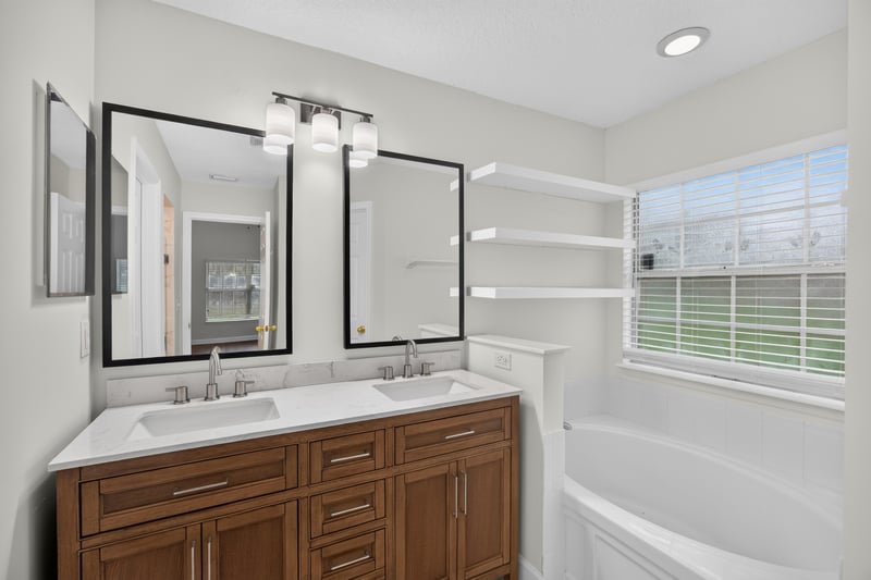 Bathroom with double sink vanity and mirror at 706 Bonaparte Dr, Jacksonville, FL 32218