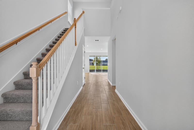 Hallway view toward staircase and rear windows at 269 Bluegrass Wy, St. Augustine, FL 32092