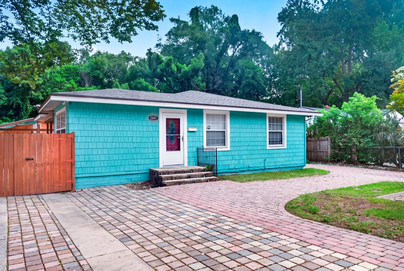 Front exterior with brick paver driveway and mature trees at 2841 Ernest St, Jacksonville, FL 32205