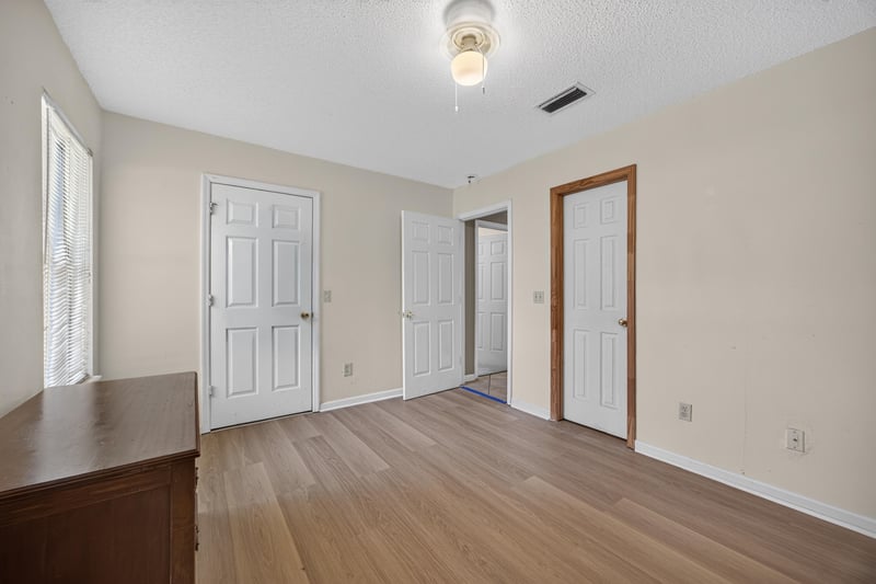 Hallway with wood laminate flooring at 5375 Dodge Rd, Jacksonville, FL 32209