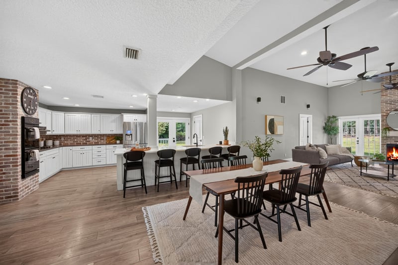 Kitchen with brick fireplace and open dining area at 1161 Whispering Pines Rd, Jacksonville, FL 32259