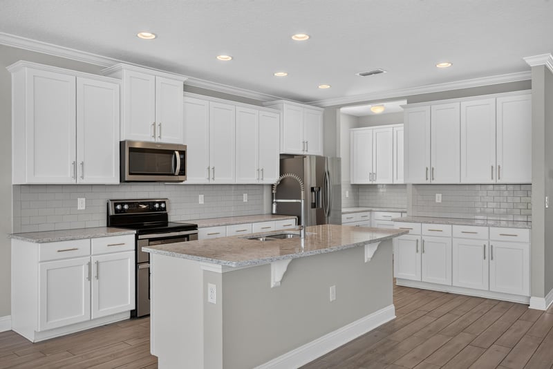 Kitchen view toward stairs with white cabinets at 2580 Cold Stream Ln, Green Cove Springs, FL 32043