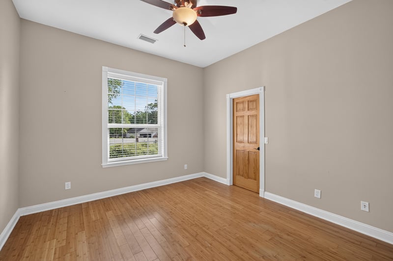Bedroom with hardwood floors and window at 1735 Hagans Ridge Ct