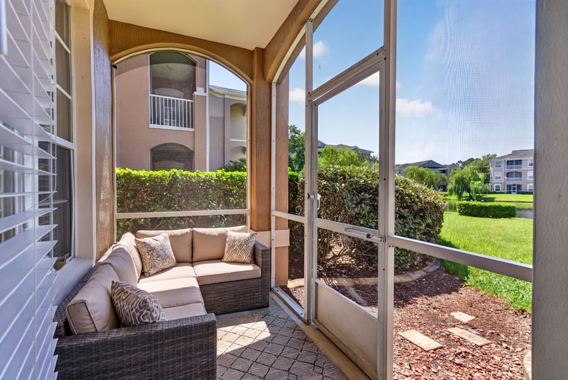 Screened porch with seating area at 7990 Baymeadows Rd E #404, Jacksonville, FL 32256