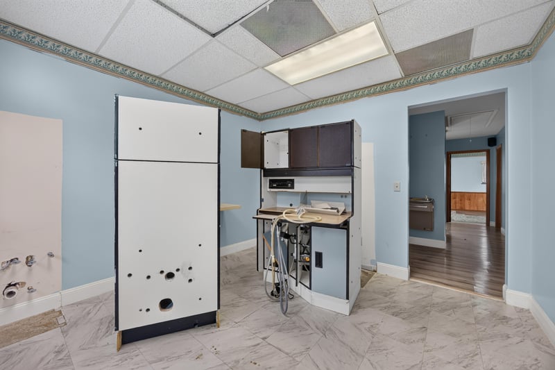 Kitchenette with cabinets, counter and doorway at 1543 Kingsley Ave #19, Orange Park, FL 32073
