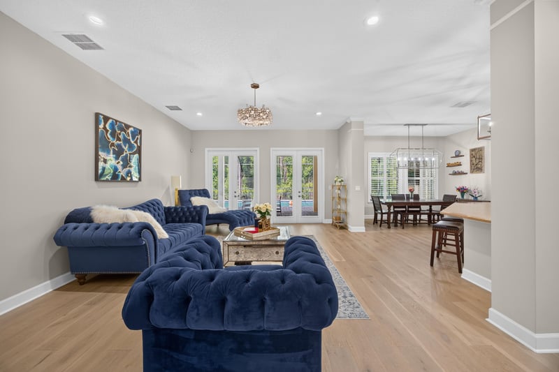 Living room with blue sofas open to kitchen at 276 Cross Ridge Dr, Ponte Vedra Beach, FL 32081