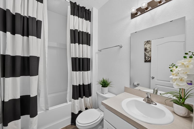 Bathroom vanity with sink and mirror at 65255 Frst Glen Ln, Yulee, FL 32097