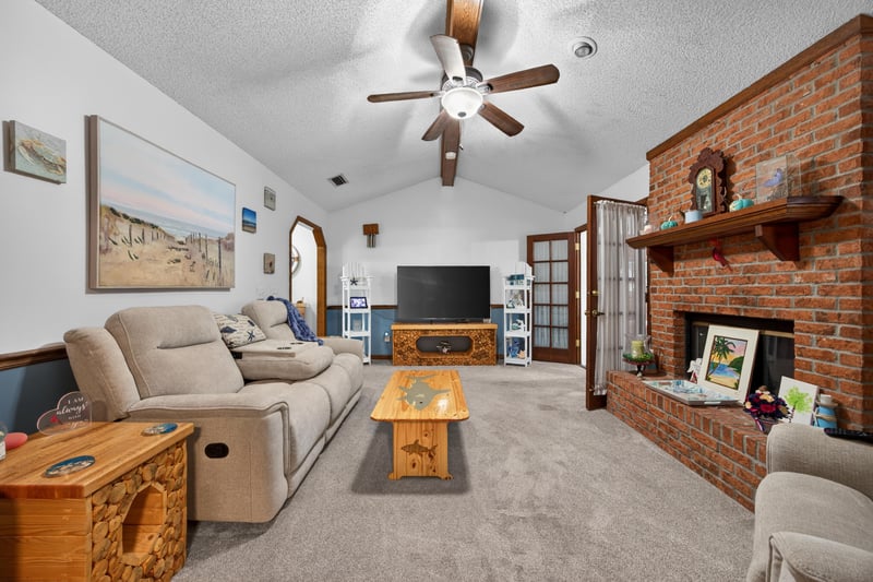 Living room with brick fireplace and vaulted ceiling at 981 Marble Ridge Dr, Orange Park, FL 32065