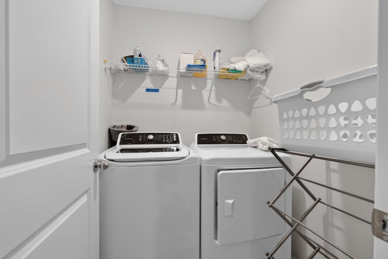Laundry shelving with washer and dryer at 1186 Beach Dune Dr, Jacksonville, FL 32233