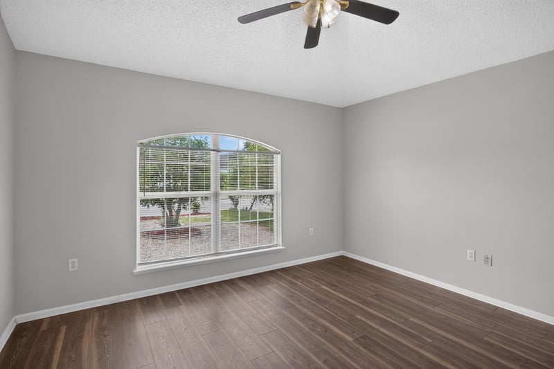 Bedroom with wood-look flooring and window at 7329 Lawn Tennis Ln, Jacksonville, FL