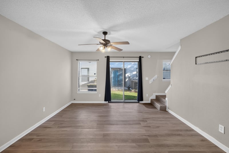 Room with windows and staircase visible at 7723 Playschool Ln, Jacksonville, FL