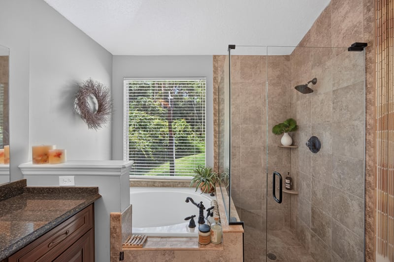 Bathroom with soaking tub and window at 1820 Burgess Hill Dr E, Jacksonville, FL