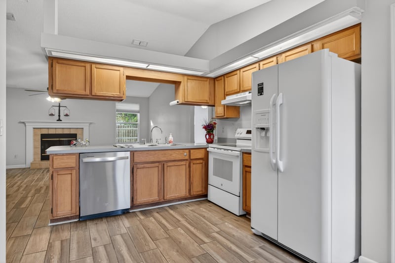 Kitchen with white refrigerator and stainless dishwasher at 2164 Orangewood St, Middleburg, FL 32068