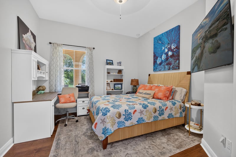 Bedroom with coastal artwork and wall sconces at 140 Ave De La Mer, Palm Coast, FL 32137