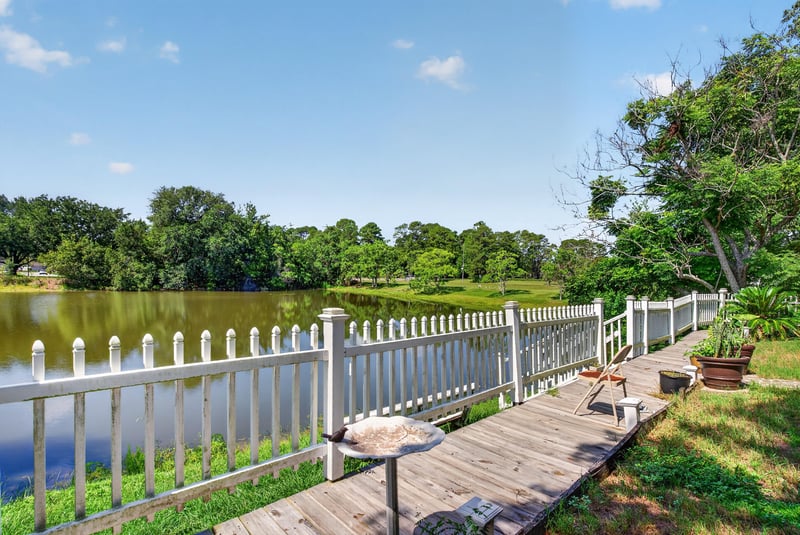 Pond view with boardwalk and white fence at 8680 Bandera Cir S, Jacksonville, FL 32244