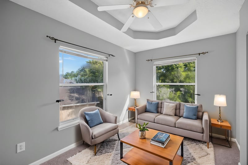 Bedroom staged with sofa and lamps at 470 Sparrow Branch Cir, Jacksonville, FL 32259