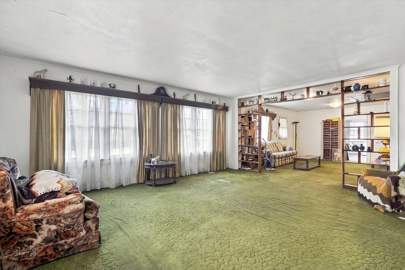 Living room with wood beam accent and seating area at 1807 Idlewild Ave, Green Cove Springs, FL