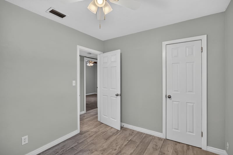 Bedroom, wood-look floors and closet door at 2256 Inwood Cir S, Jacksonville, FL