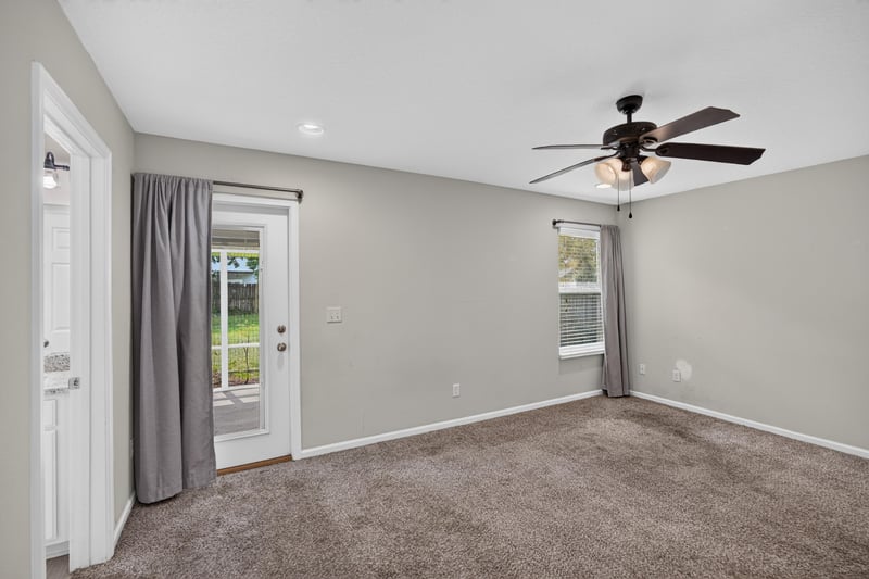 Empty carpeted room with curtain and sliding door at 1002 Ingleside Ave, Jacksonville, FL 32205