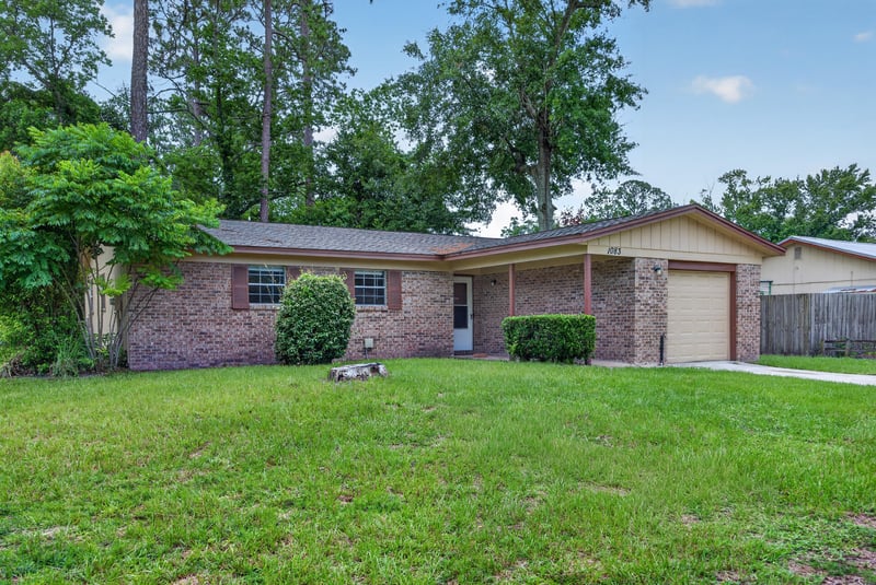 Front exterior view showing driveway and garage door at 1083 Stokes St, Jacksonville, FL