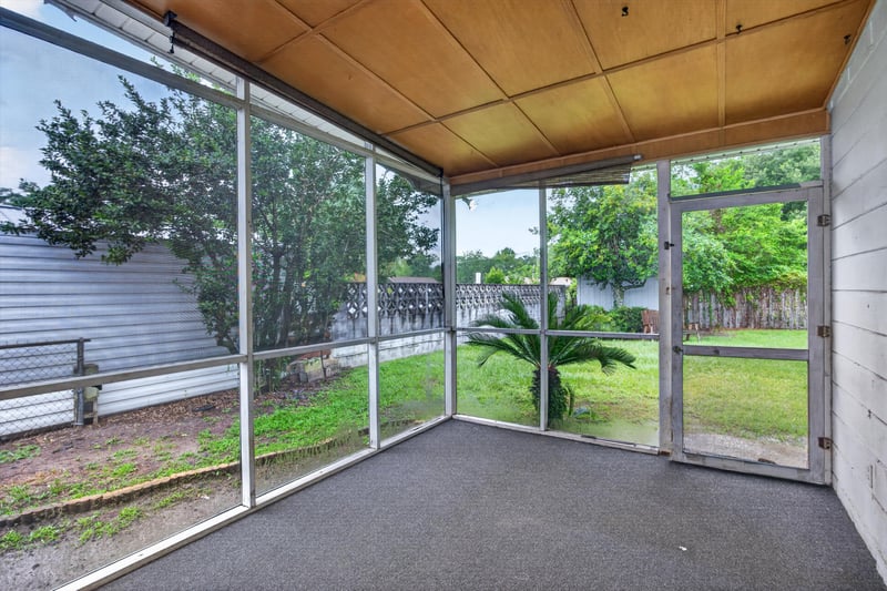 Screened porch with trees beyond the screen at 11462 Elane Dr, Jacksonville, FL