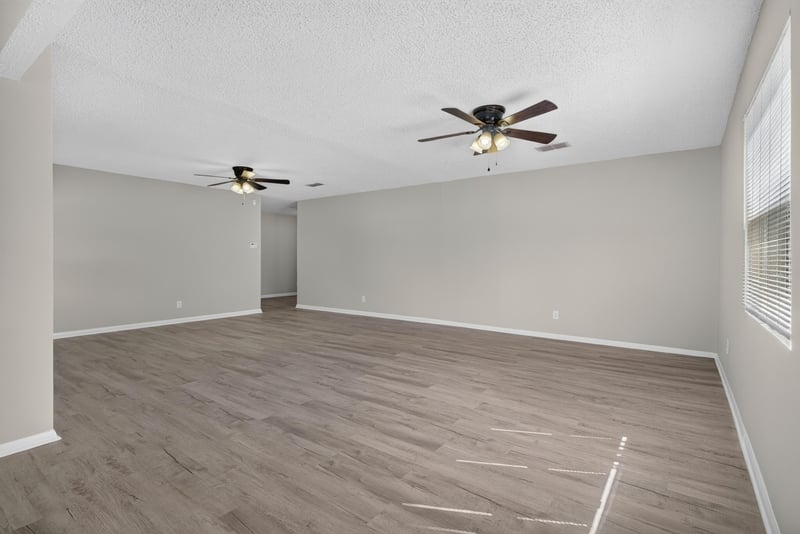 Living space with ceiling fan and wood-look floor at 5503 Boeing Dr, Jacksonville, FL 32207