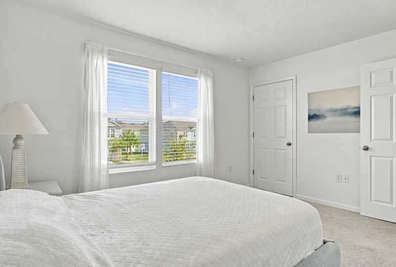 Bedroom with bed and two windows at 8359 Zenith Cir, Jacksonville, FL 32256