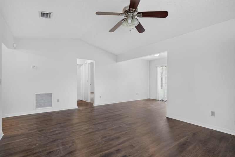 Open living and dining area with ceiling fan at 1445 Classic Oak Rd W, Jacksonville, FL