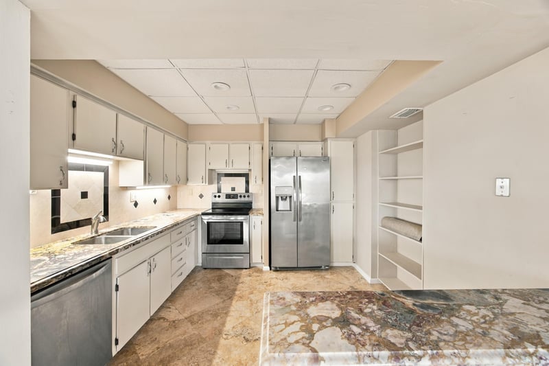 Kitchen with stainless refrigerator and tile floor at 752 Spinnakers Reach Dr, Ponte Vedra Beach, FL 32082