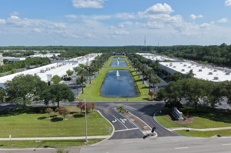 Aerial view of a rectangular pond with fountain between parking lots at 10550 Deerwood Park Blvd, Jacksonville, FL 32256
