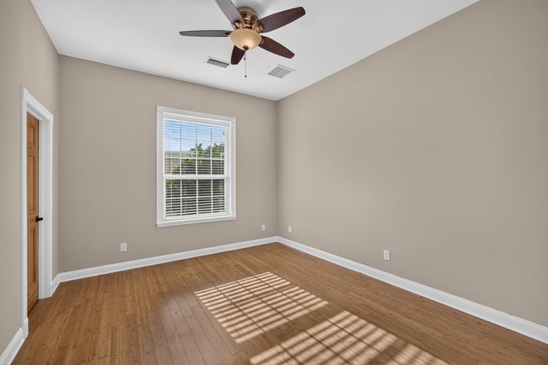 Bedroom with hardwood floors and window at 1735 Hagans Ridge Ct