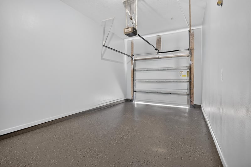 Garage interior with epoxy flooring at 8196 Cabin Lake Cir, Jacksonville, FL 32256