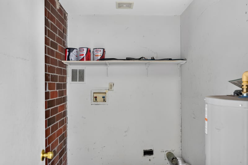 Utility closet with brick wall and shelving at 2658 Trollie Ln apt 1, Jacksonville, FL 32211