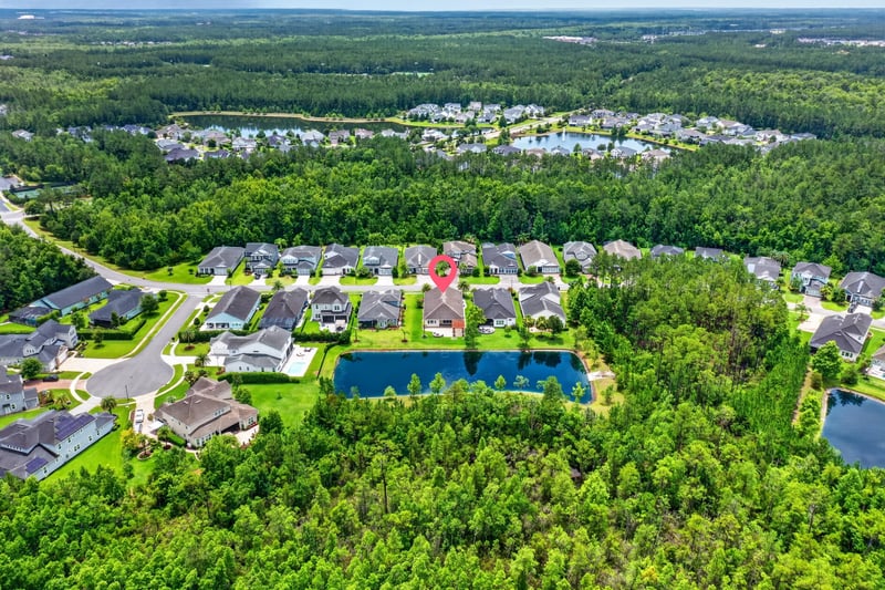 Aerial view of neighborhood streets and tree canopy in St. Johns, FL