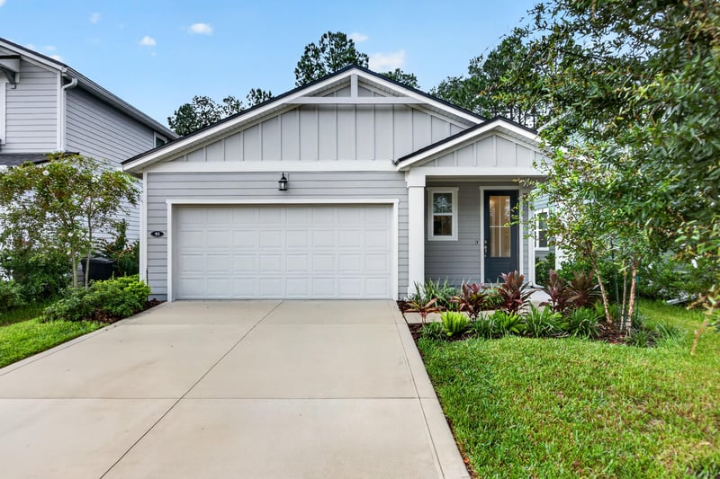 Front exterior view with driveway and landscaping at 93 Lochloosa Ct, St. Johns, FL 32259