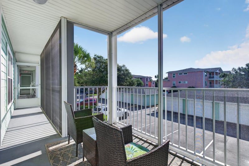 Screened porch with seating and tree view at 206 16th St, St. Augustine, FL 32080