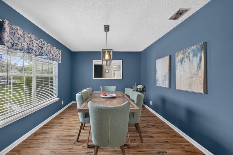 Dining room with large window and wood floors at 12825 Kelsey Island Dr, Jacksonville, FL 32224
