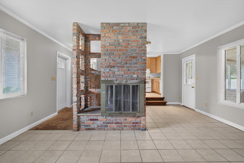 Living room with brick fireplace and tile floor at 2618 Arlex Dr E, Jacksonville, FL