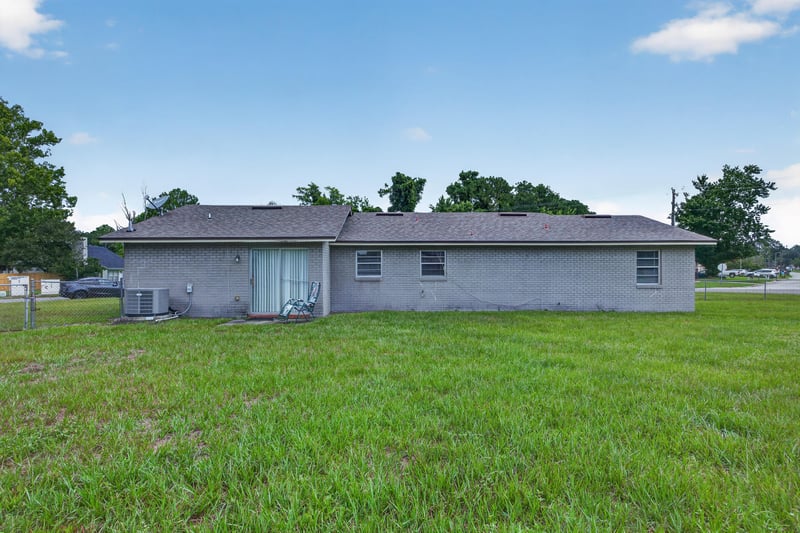 Backyard with grass and air conditioning unit at 1143 Tumbleweed Dr, Orange Park, FL 32065