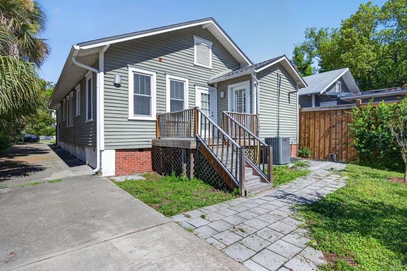 Side exterior view with back stairs and AC unit at 1555 Belmonte Ave, Jacksonville, FL 32207