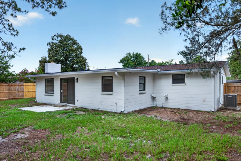 Backyard exterior with chimney and fenced yard at 184 Draco St, Orange Park, FL 32073