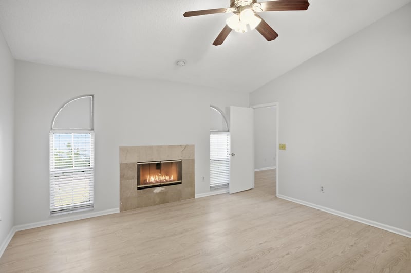 Living room with stone fireplace and window at 678 5th Ave N, Jacksonville Beach, FL 32250