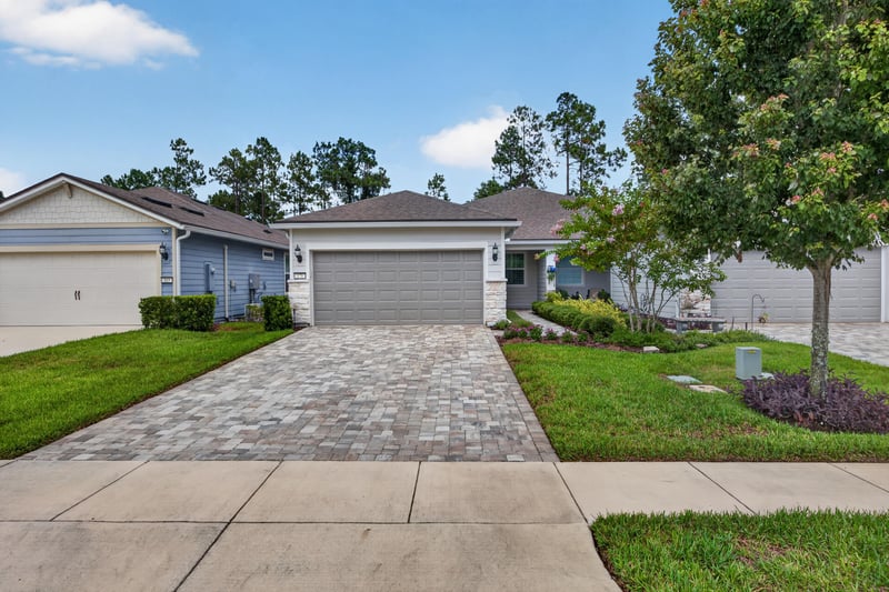 Front exterior view down the driveway toward the garage at 171 Oyster Shell Ter, Nocatee, FL 32081