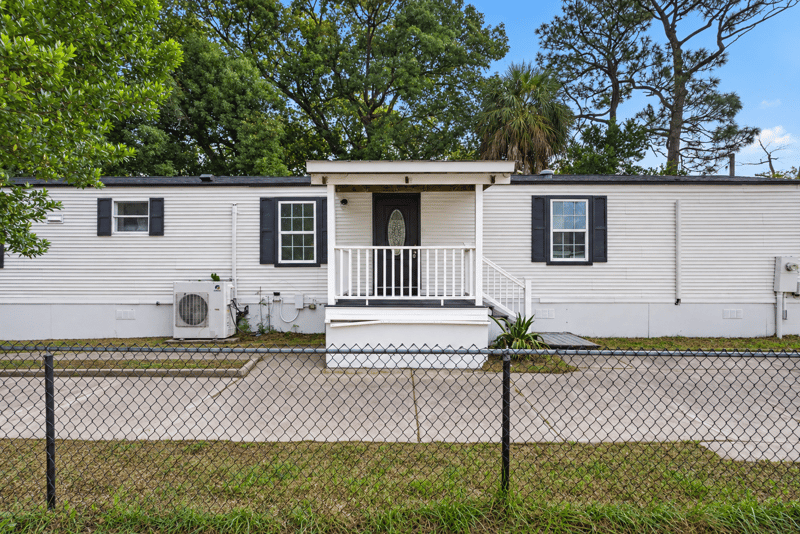 Front exterior with covered porch and fenced yard at 4565 Appleton Ave, Jacksonville, FL