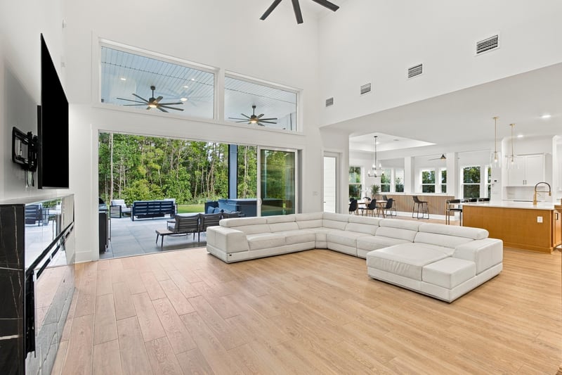 Great room with vaulted ceiling and wall of windows at 907 Seagrove Dr, Ponte Vedra Beach, FL 32081